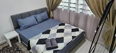 a bedroom with a bed with a checkered blanket at Teluk Intan Bajet Homestay Landed 3Bedrooms in Teluk Intan