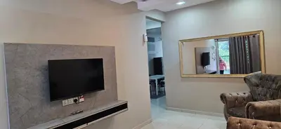 a living room with a flat screen tv on a wall at Teluk Intan Bajet Homestay Landed 3Bedrooms in Teluk Intan