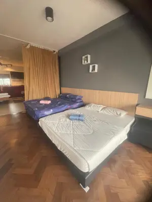 a bedroom with a bed with a blue mattress at The Landmark By Pearl Heritage Homestay & Guest House in Tanjong Tokong