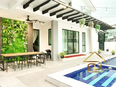 an outdoor dining area with a table and chairs next to a pool at Ipoh Fairy Villa 3 Pool, Jacuzzi & KTV 23 Pax in Ipoh