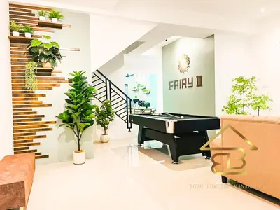 a living room with a piano and potted plants at Ipoh Fairy Villa 3 Pool, Jacuzzi & KTV 23 Pax in Ipoh