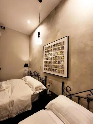 a bedroom with two beds and a picture on the wall at Deer Farm Pool Villa 5BR 27pax by One Life Four Season Guesthouse in Tanjung Rambutan