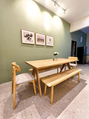 a wooden table and a bench and a table and chairs at Deer Farm Pool Villa 5BR 27pax by One Life Four Season Guesthouse in Tanjung Rambutan