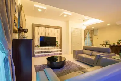 a living room with a couch and a tv at Ipoh Sky Pool Villa, 20 Pax with Kbox, Gym & BBQ in Ipoh