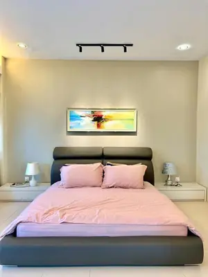 a bedroom with a large bed with pink sheets at Ipoh Sky Pool Villa, 20 Pax with Kbox, Gym & BBQ in Ipoh