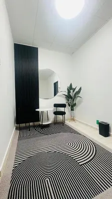 a room with a black and white rug and a table at D'Zebra Homestay Tambun in Kampong Batu Lapan