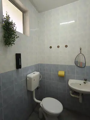 a bathroom with a toilet and a sink at Tambun Apartment - Boho Natura in Tambun
