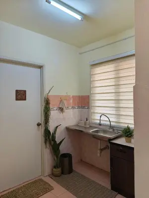 a bathroom with a sink and a counter and a window at Tambun Apartment - Boho Natura in Tambun
