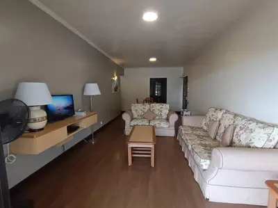 a living room with a white couch and a tv at Homestay Cameron Highlands at Copthorne in Brinchang