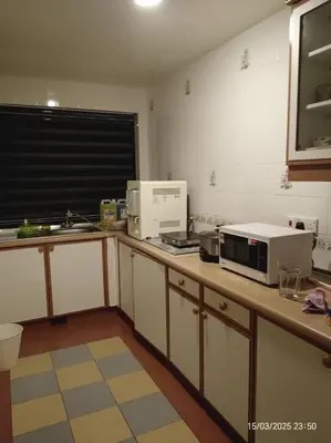 a kitchen with a microwave and appliances on a counter at Homestay Cameron Highlands at Copthorne in Brinchang