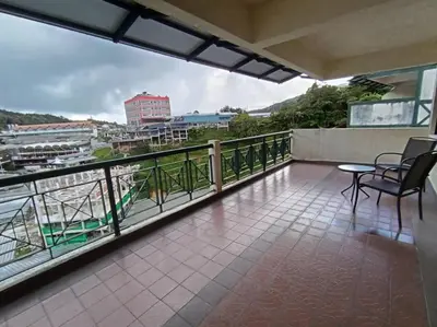 a balcony with chairs and a view of a city at Homestay Cameron Highlands at Copthorne in Brinchang