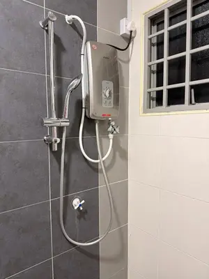 a shower with a soap dispenser in a bathroom at PRS Bungalow Homestay in Ipoh
