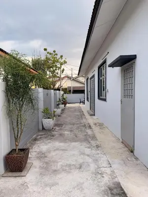 a hallway of a white house with a driveway at PRS Bungalow Homestay in Ipoh