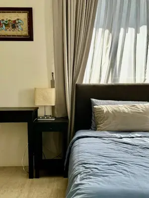 a bedroom with a bed with a lamp and a window at By The Sea partial seaview 2BR 6pax Batu Ferringhi in Batu Ferringhi