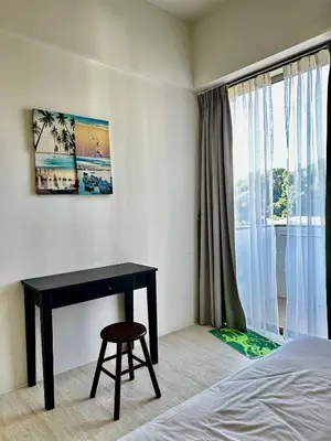 a bedroom with a desk and a bed and a window at By The Sea partial seaview 2BR 6pax Batu Ferringhi in Batu Ferringhi