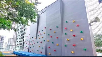 a wall with a climbing wall with umbrellas on it at Wanderlust Retreat 3R by Urban Suites in George Town