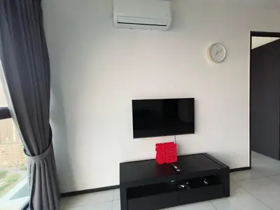 a living room with a flat screen tv on a wall at Urban Suites, Penang in George Town