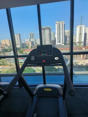 a gym with a view of a city from a window at Urban Suites, Penang in George Town
