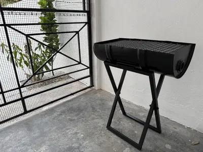 a bbq grill sitting next to a door at Green Living Homestay Bercham 8 Pax in Ipoh