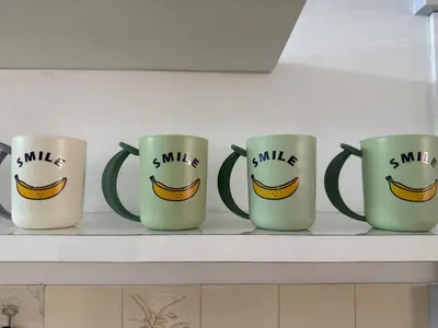 four coffee mugs with smiles on them on a shelf at Green Living Homestay Bercham 8 Pax in Ipoh