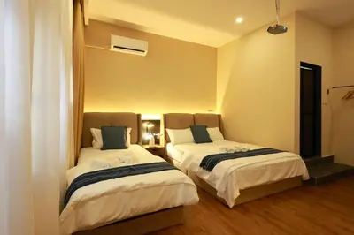 two beds sitting in a room with at The Cintra Muse Hotel at Central of Georgetown and UNESCO in George Town