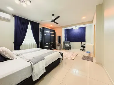 a bedroom with a bed and a living room at Manjung Cozy Stay in Seri Manjung