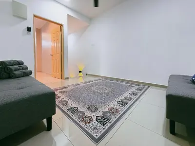a living room with two couches and a rug at Manjung Cozy Stay in Seri Manjung