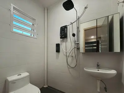 a bathroom with a shower and a toilet and a sink at Manjung Cozy Stay in Seri Manjung