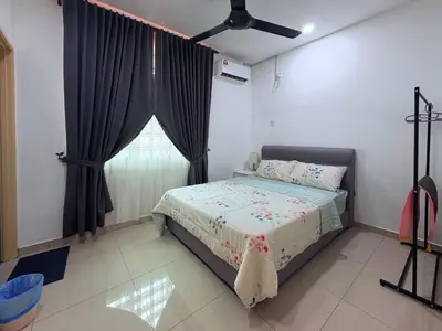 a bedroom with a bed and a window at Manjung Cozy Stay in Seri Manjung
