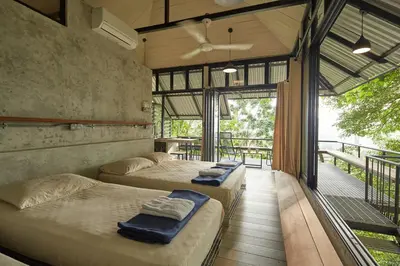 two beds in a room with a balcony at Stunning Mountain View Lodge with Pool Lauhaus2 in Kuala Kubu Baharu