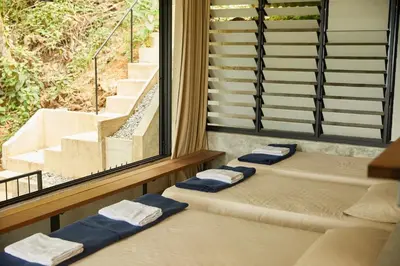 two beds in a room with a window at Stunning Mountain View Lodge with Pool Lauhaus2 in Kuala Kubu Baharu