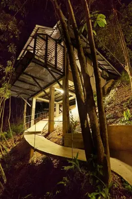 a building with a roof in the middle of a forest at Stunning Mountain View Lodge with Pool Lauhaus2 in Kuala Kubu Baharu