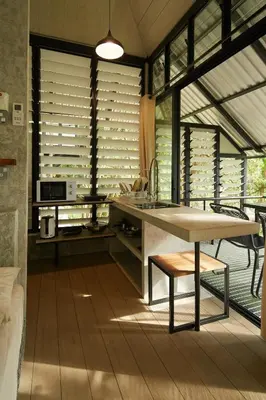 a kitchen with a sink and a table and some windows at Stunning Mountain View Lodge with Pool Lauhaus2 in Kuala Kubu Baharu