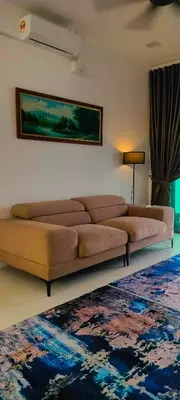 a living room with a brown couch and a rug at Homestay odah dan hana teluk intan 3R2T in Teluk Intan