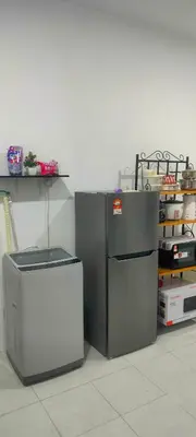 a refrigerator and a trash can in a room at Homestay odah dan hana teluk intan 3R2T in Teluk Intan
