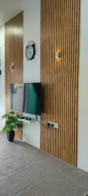 a wooden door with a clock and a plant at Homestay odah dan hana teluk intan 3R2T in Teluk Intan