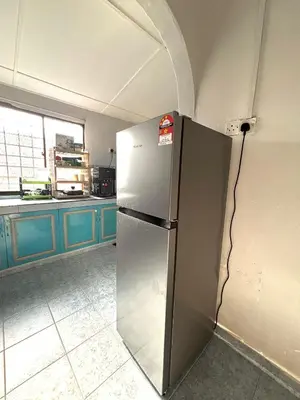 a kitchen with a stainless steel refrigerator in a room at BUDI HOMESTAY Meru Jaya in Ipoh