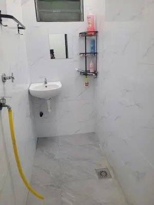 a white bathroom with a sink and a shower at BUDI HOMESTAY Meru Jaya in Ipoh
