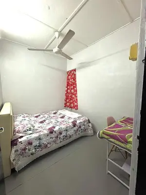 a bedroom with a bed and a ceiling fan at BUDI HOMESTAY Meru Jaya in Ipoh