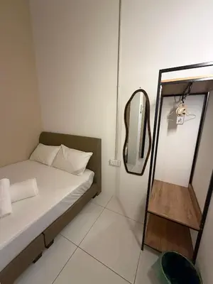 a small room with a bed and a mirror at Amore Stay by BNB4U in George Town