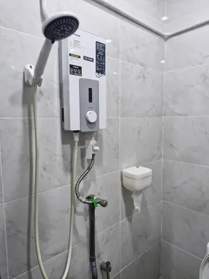 a shower in a bathroom with a toilet at Amore Stay by BNB4U in George Town