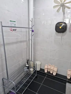 a bathroom with a shower with shoes on the floor at Amore Stay by BNB4U in George Town