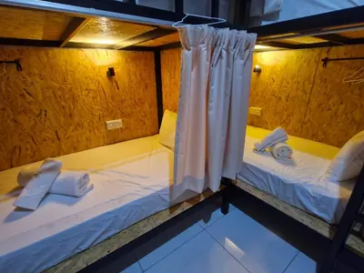 two beds in a room with white sheets and towels at Amore Stay by BNB4U in George Town