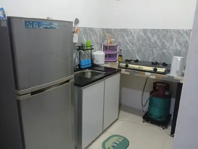 a small kitchen with a refrigerator and a sink at HomeStay YNS Kampar Putra Perak 2 Bilik dan 2 Bilik Air in Kampar