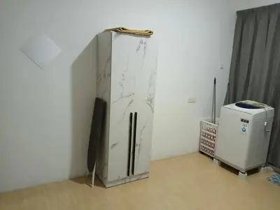 a refrigerator in a corner of a room with a counter at HomeStay YNS Kampar Putra Perak 2 Bilik dan 2 Bilik Air in Kampar