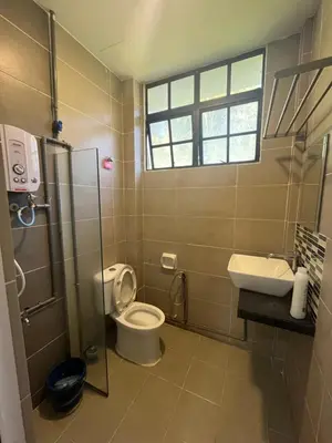a bathroom with a toilet and a sink at White rose Vila Taman sedia in Tanah Rata