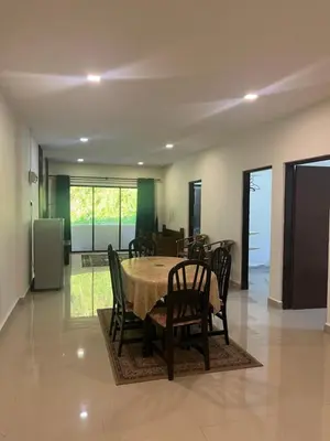 a dining room with a table and chairs at White rose Vila Taman sedia in Tanah Rata