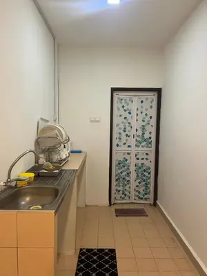 a kitchen with a sink and a door to a room at White rose Vila Taman sedia in Tanah Rata