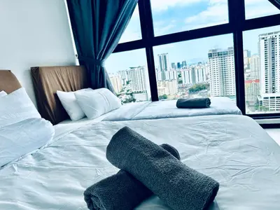 a bedroom with two beds and a large window at Urban Suites 3R2B 11pax Deluxe Living Room in George Town