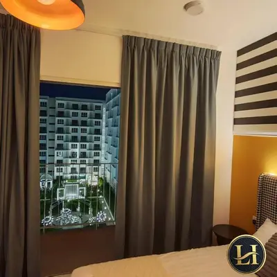 a bedroom with a window with a view of a city at The Stallionz Classy Suites by LH - Ipoh Town in Ipoh
